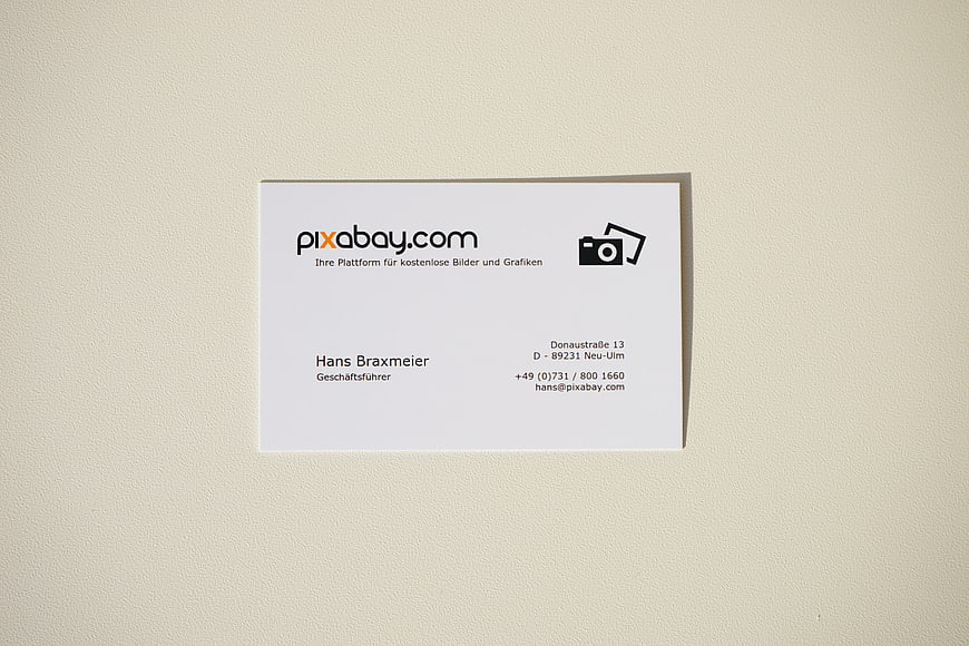 Minimalist white business card mockup on textured beige background