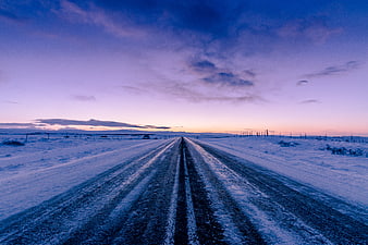 Snowy Winter Road at Dusk with Purple Sky