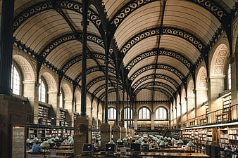 Grand Victorian Library Interior with Arched Ceilings and Readers