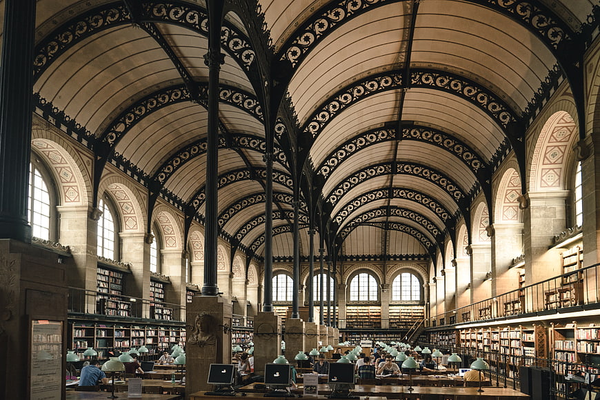 Grand Victorian Library Interior with Arched Ceilings and Readers