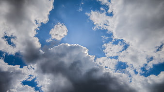 Dramatic white clouds against a bright blue sky