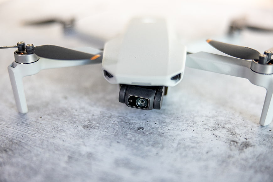 Close-up of white drone camera on textured concrete surface