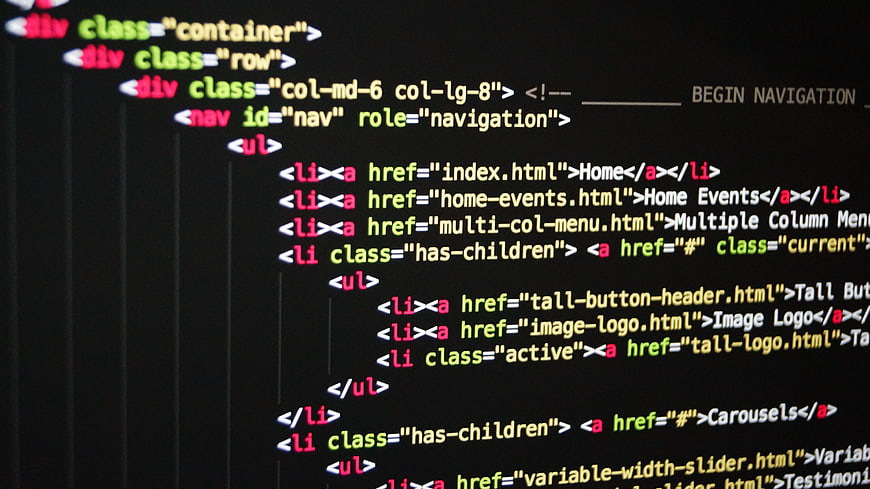 Close-up of HTML code on a dark computer screen