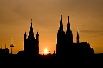 Silhouette of Cologne Cathedral and Great St. Martin Church at Sunset