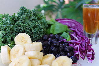 Fresh kale, banana, blueberries, red cabbage, and juice for healthy smoothie
