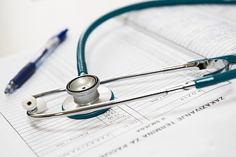 Stethoscope on Medical Appointment Form and Notebook