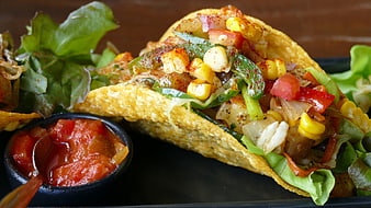 Close-up of vegetarian taco with corn, peppers, and salsa