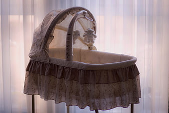 Vintage Baby Bassinet with Mobile in Soft Light