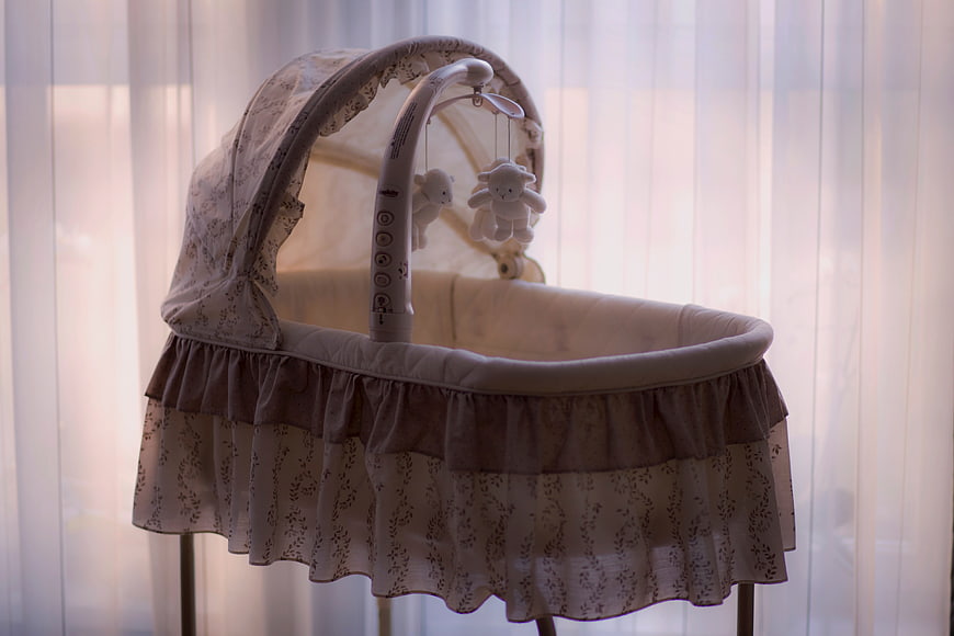 Vintage Baby Bassinet with Mobile in Soft Light