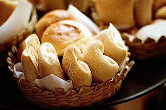 Freshly baked bread rolls in a woven basket
