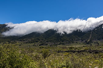 Misty Mountain Landscape with Clouds and Green Valley