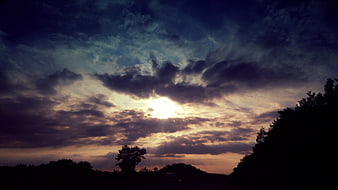 Dramatic Sunset Sky with Sun Rays Through Clouds