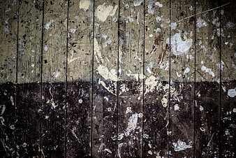 Grungy wooden texture with paint splatters and peeling layers