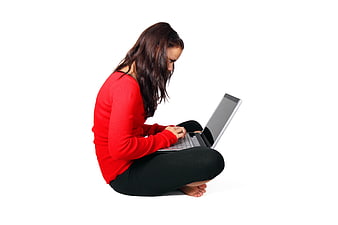 Young woman in red sweater typing on laptop isolated on white