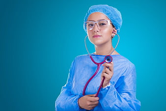 Female Surgeon in Blue Scrubs Holding Stethoscope