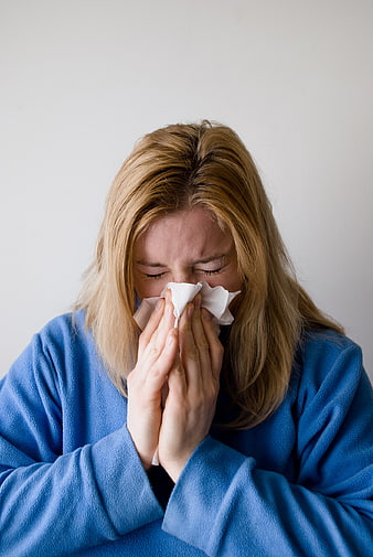 Sick Woman Blowing Nose with Tissue