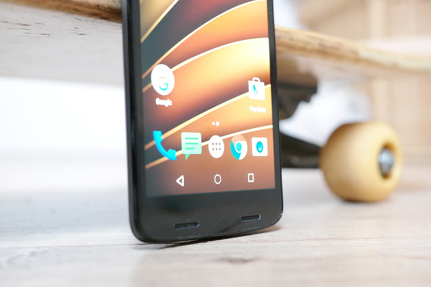 Smartphone on wooden table with skateboard in background