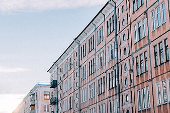 Low angle view of pink apartment building facade