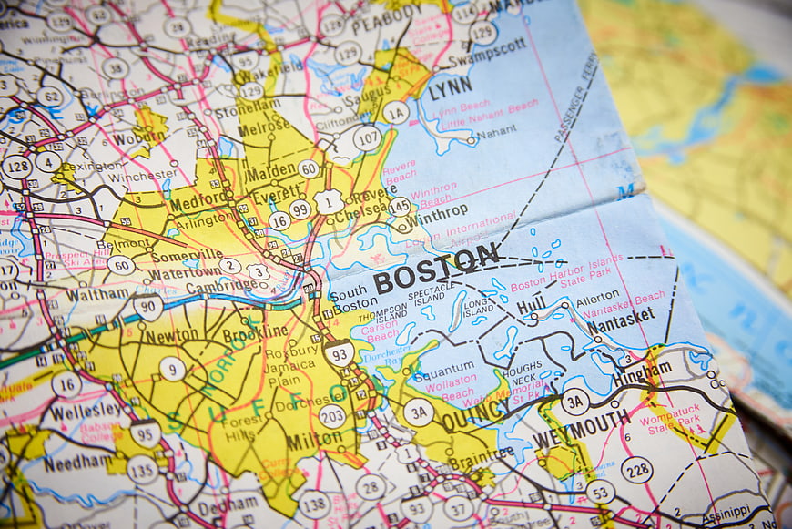 Close-up of a folded paper map showing Boston and surrounding areas