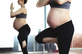 Pregnant Woman Practicing Yoga in Studio
