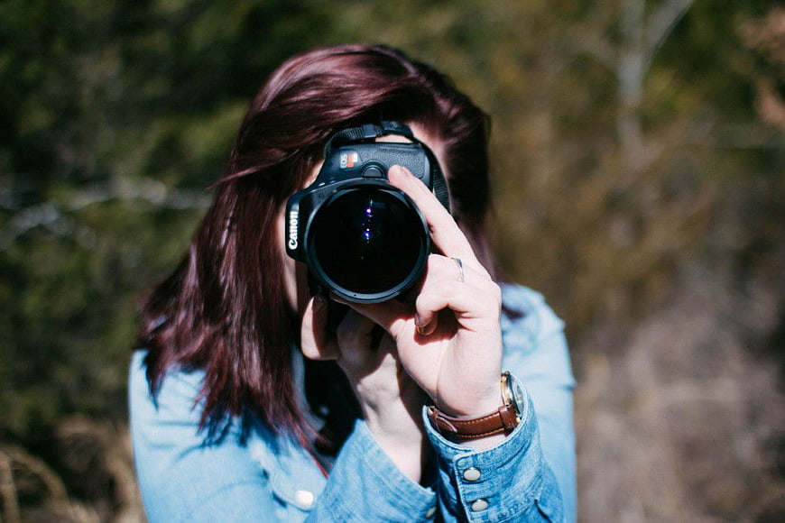 Woman Photographer Holding DSLR Camera Outdoors