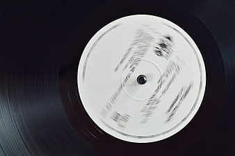 Spinning vinyl record with white label and motion blur