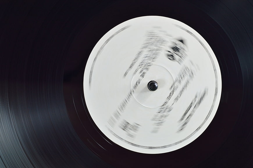 Spinning vinyl record with white label and motion blur