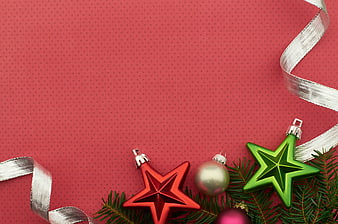 Christmas ornaments and pine branches on red background