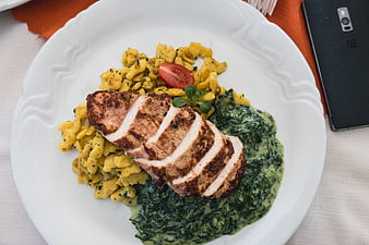 Sliced grilled chicken breast with spinach and gnocchi