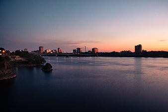 Serene City Skyline at Dusk Over Calm River