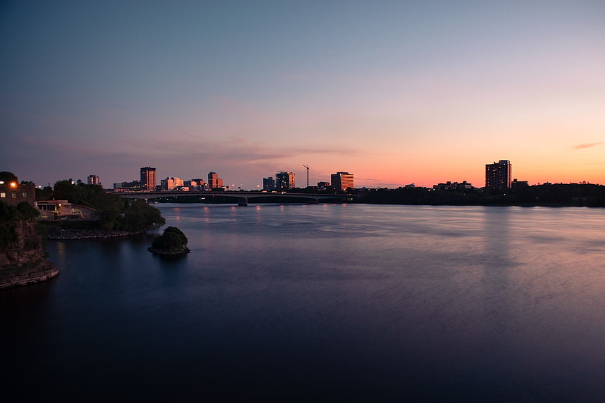Serene City Skyline at Dusk Over Calm River