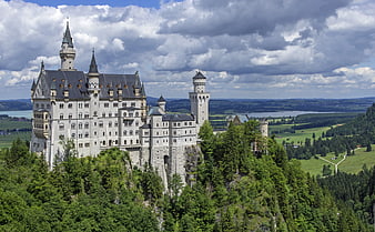 Neuschwanstein Castle on Hilltop with Green Forest and Lake