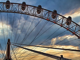 Ferris Wheel Structure Against Dramatic Sunset Sky