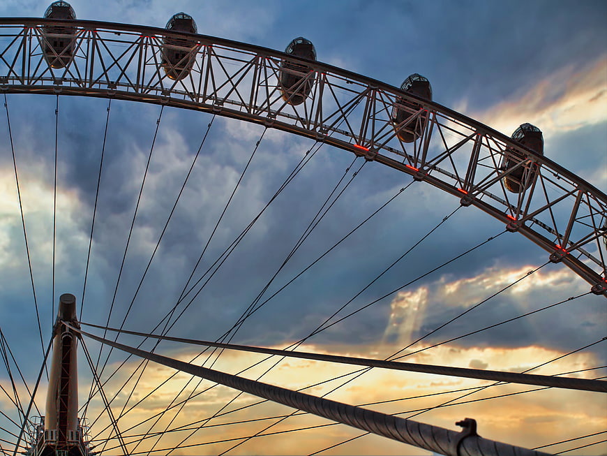 Ferris Wheel Structure Against Dramatic Sunset Sky