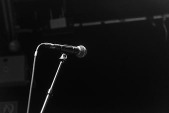 Black and white microphone on stand in dark studio
