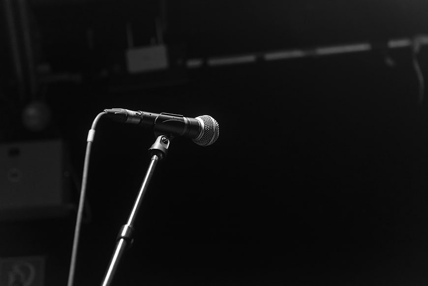 Black and white microphone on stand in dark studio
