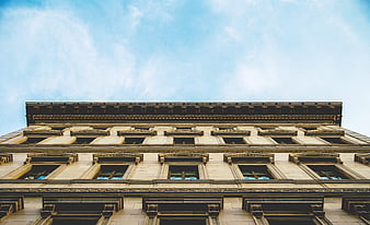 Low angle view of classical building facade against blue sky