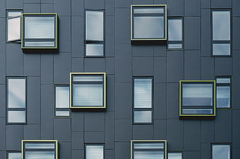 Modern gray building facade with geometric window pattern