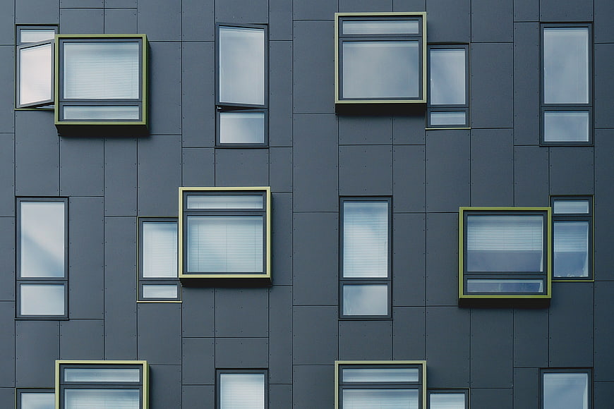Modern gray building facade with geometric window pattern