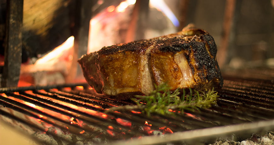 Grilled Florentine Steak with Rosemary on Charcoal Grill