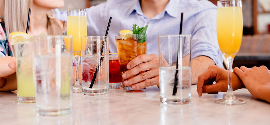 Friends enjoying cocktails and drinks at a restaurant table
