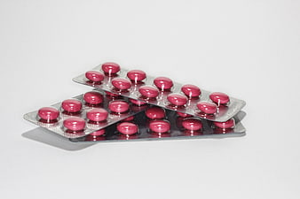 Pink Pills In Silver Blister Packs On White Background