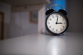 Vintage Black Alarm Clock on White Surface