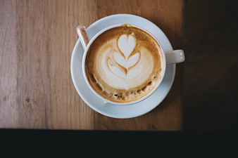 Top View of Latte Art Coffee Cup on Wooden Table