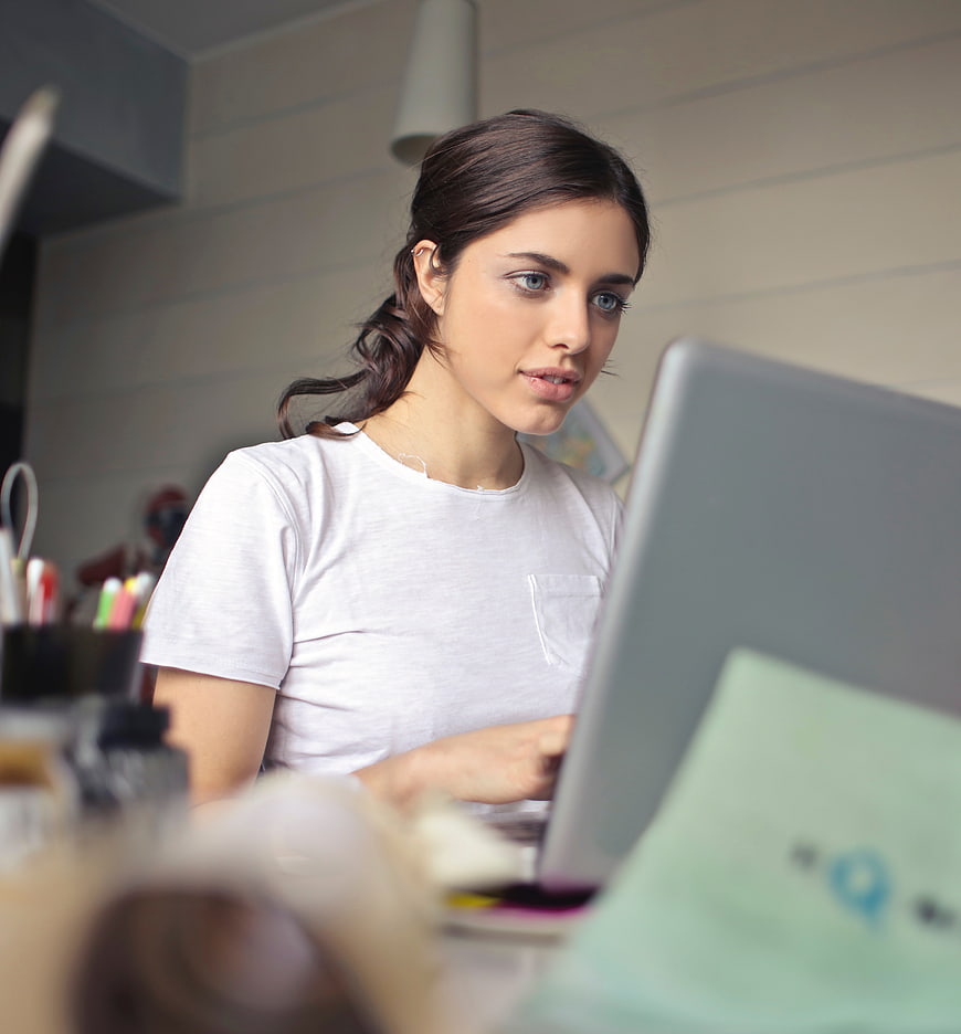 Young woman working on laptop in home office