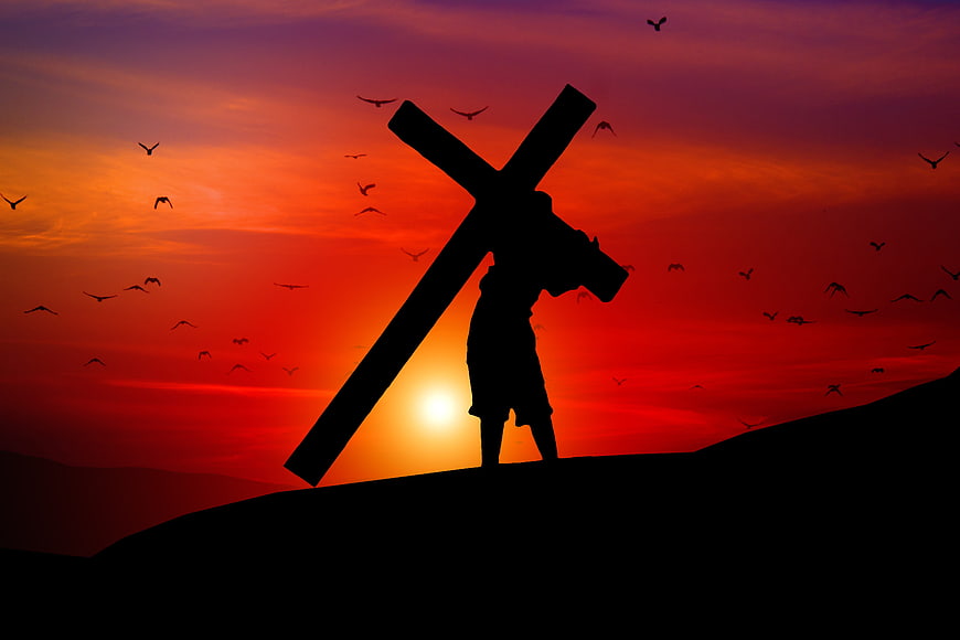 Silhouette of Jesus Carrying Cross at Sunset