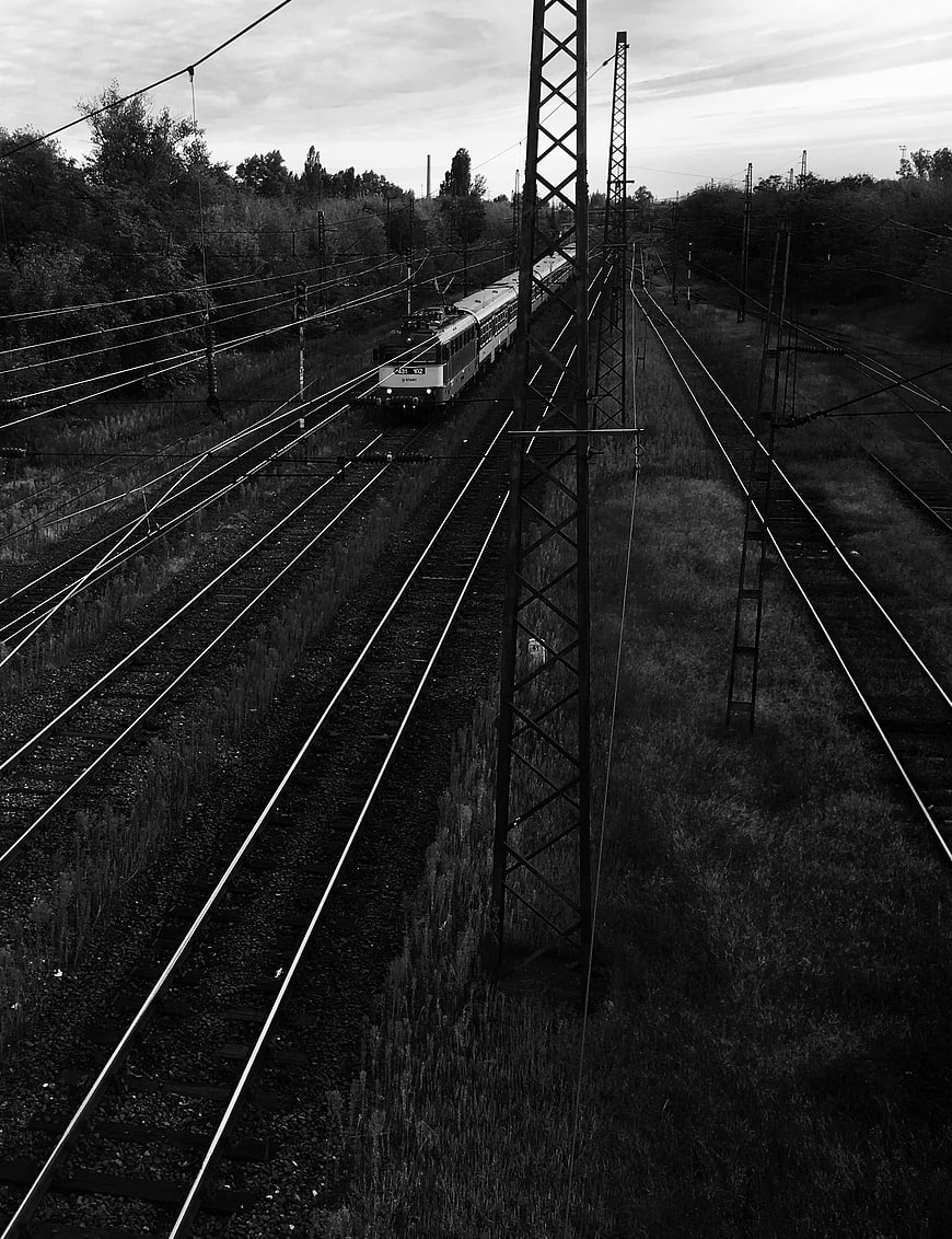 Black and white train on railway tracks
