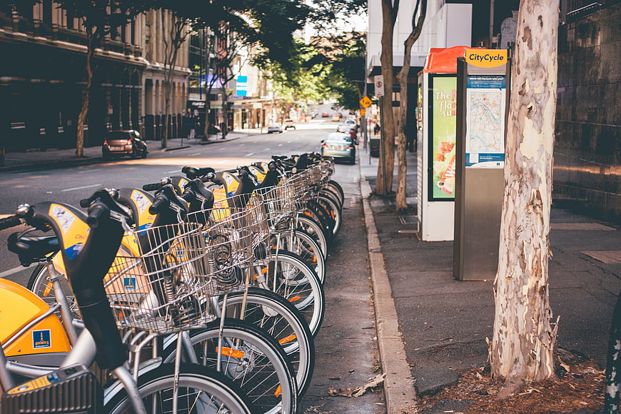 Row of yellow CityCycle bicycles parked on urban street