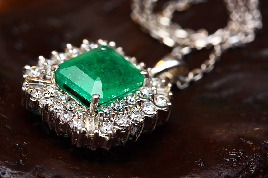 Luxury Emerald Pendant Necklace with Diamonds on Dark Wood