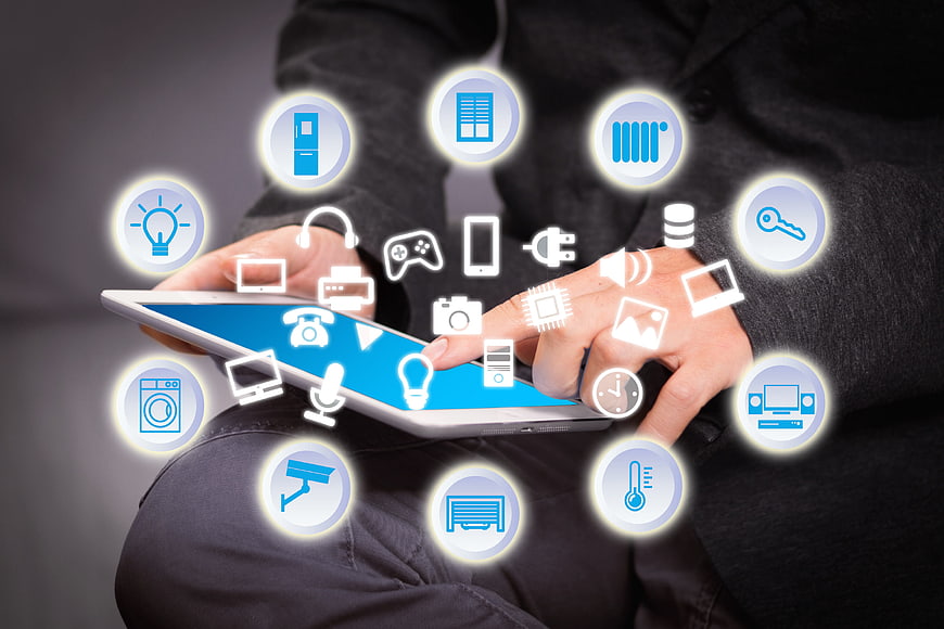 Person Using Tablet With Smart Home Technology Icons